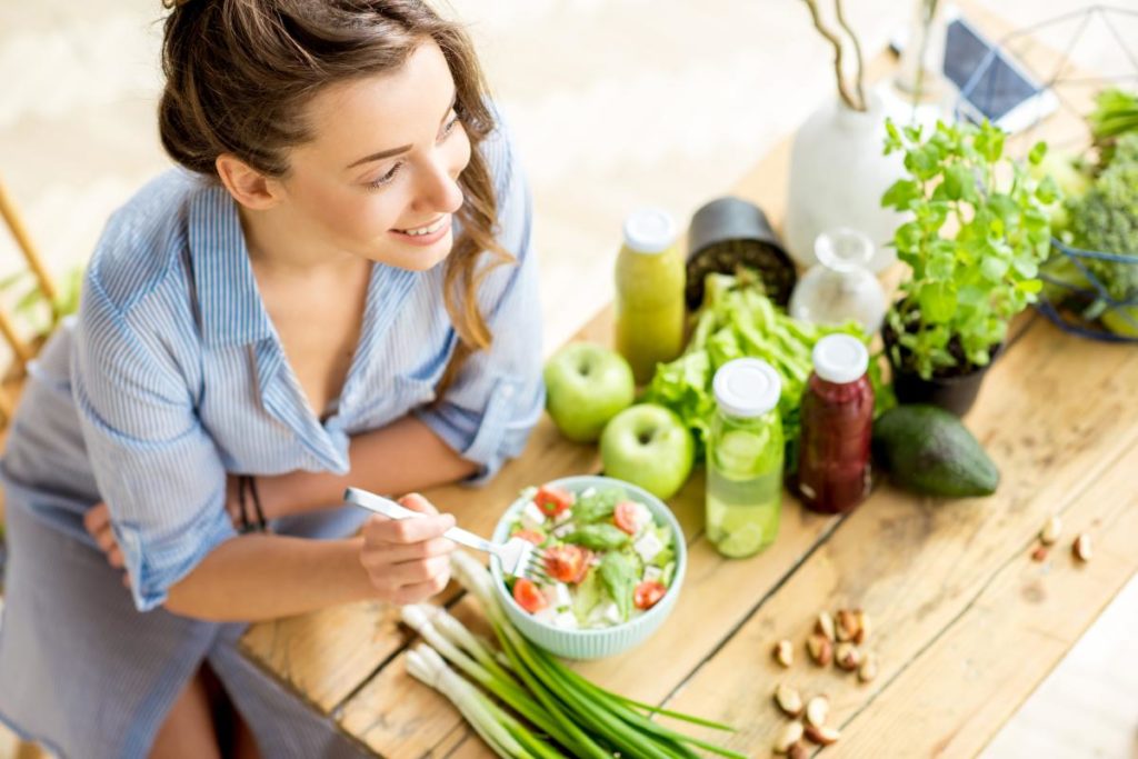 woman preparing vegetables while maintaining sobriety