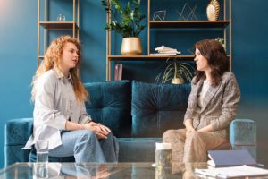 two people sit and talk possibly about Getting through alcohol withdrawal