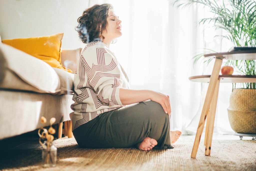 a person meditates on the floor one of the healthy Coping mechanisms for substance abuse