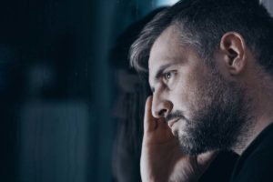 A person looks sadly profile-side off camera after learning the signs of cocaine use