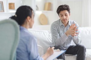 a person talks to a therapist about the benefits of Partial hospitalization vs intensive outpatient