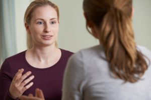 a patient goes over examples of a relapse prevention plan with a therapist